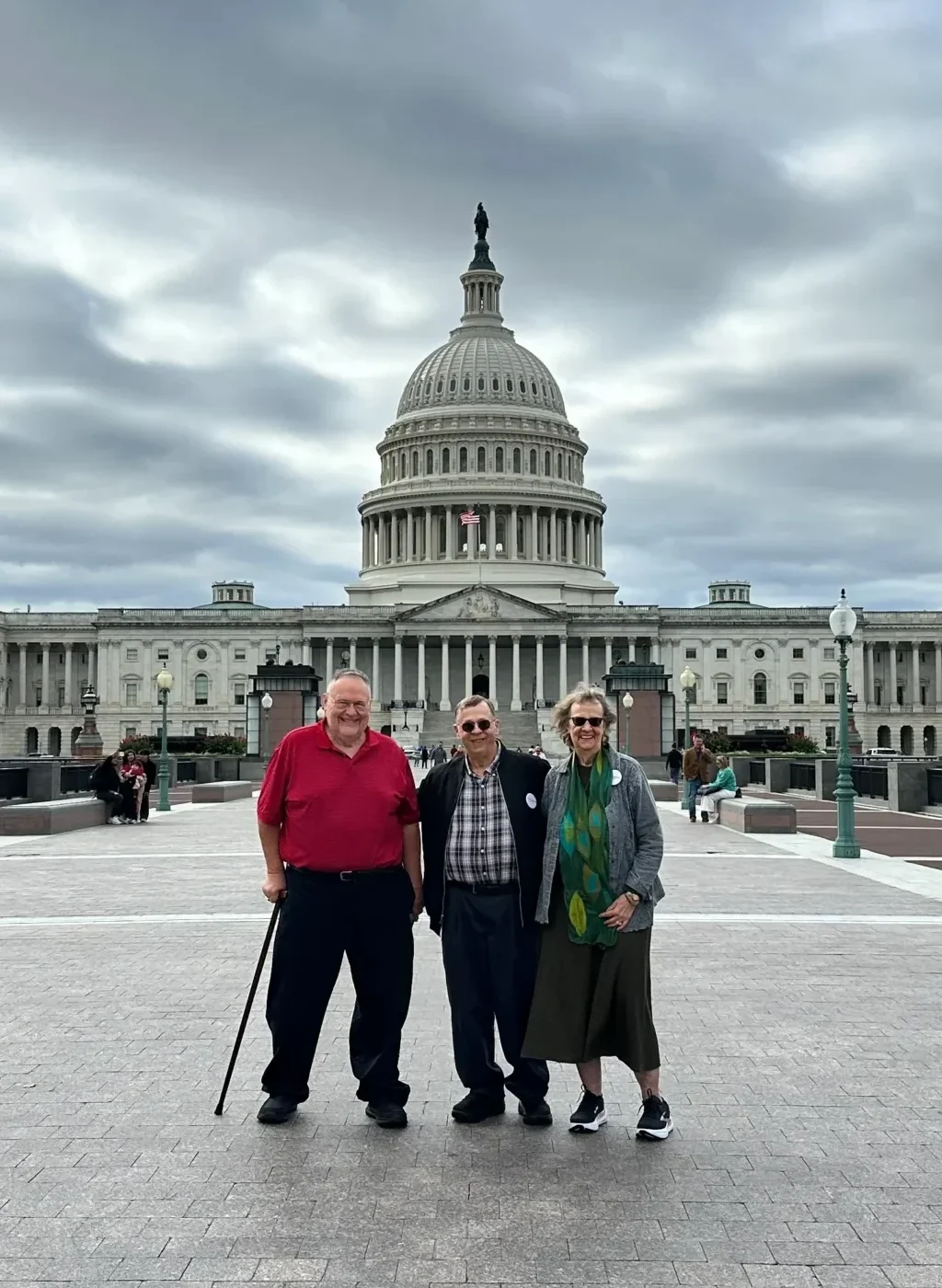 three seniors stand in front of the US Capitol building in Washington DC